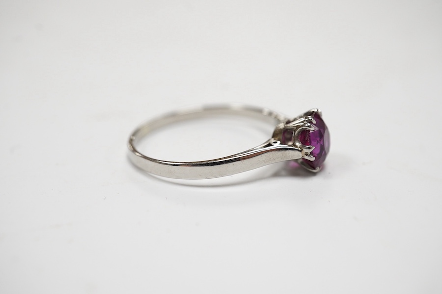 A white metal (stamped plat) and solitaire ruby set ring, size L, gross weight 2.2 grams. Condition - poor to fair